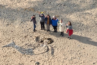 A group of eole shot from above with a sand art mermaid