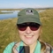 A woman wearing a green wildlife trust cap and sunglasses