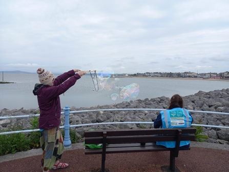 A person making large bubbles
