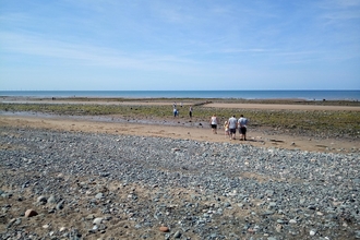 People on a pebbled beach