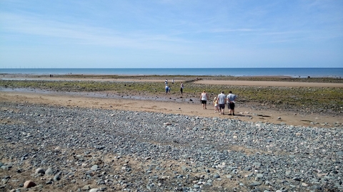 People on a pebbled beach