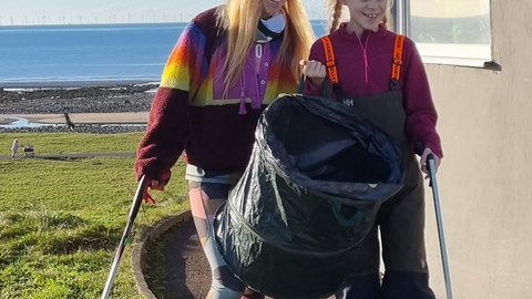 Mother and child doing a beach clean.